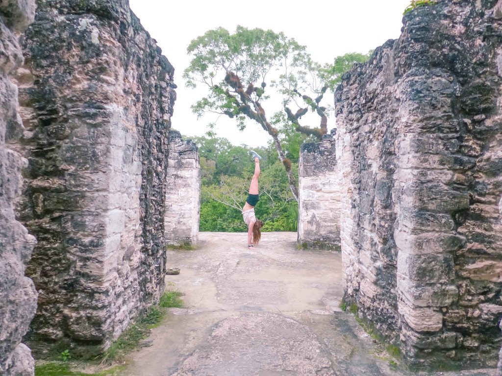 checking out temples in tikal handstand on tikal ruins