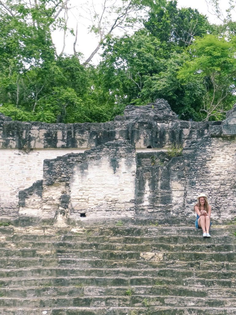 sitting in tikal guatemala sitting on the steps of tikal pyramid