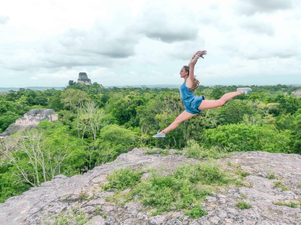 on the tikal ruins guatemala observatory jumping on the top of one of the tikal pyramids